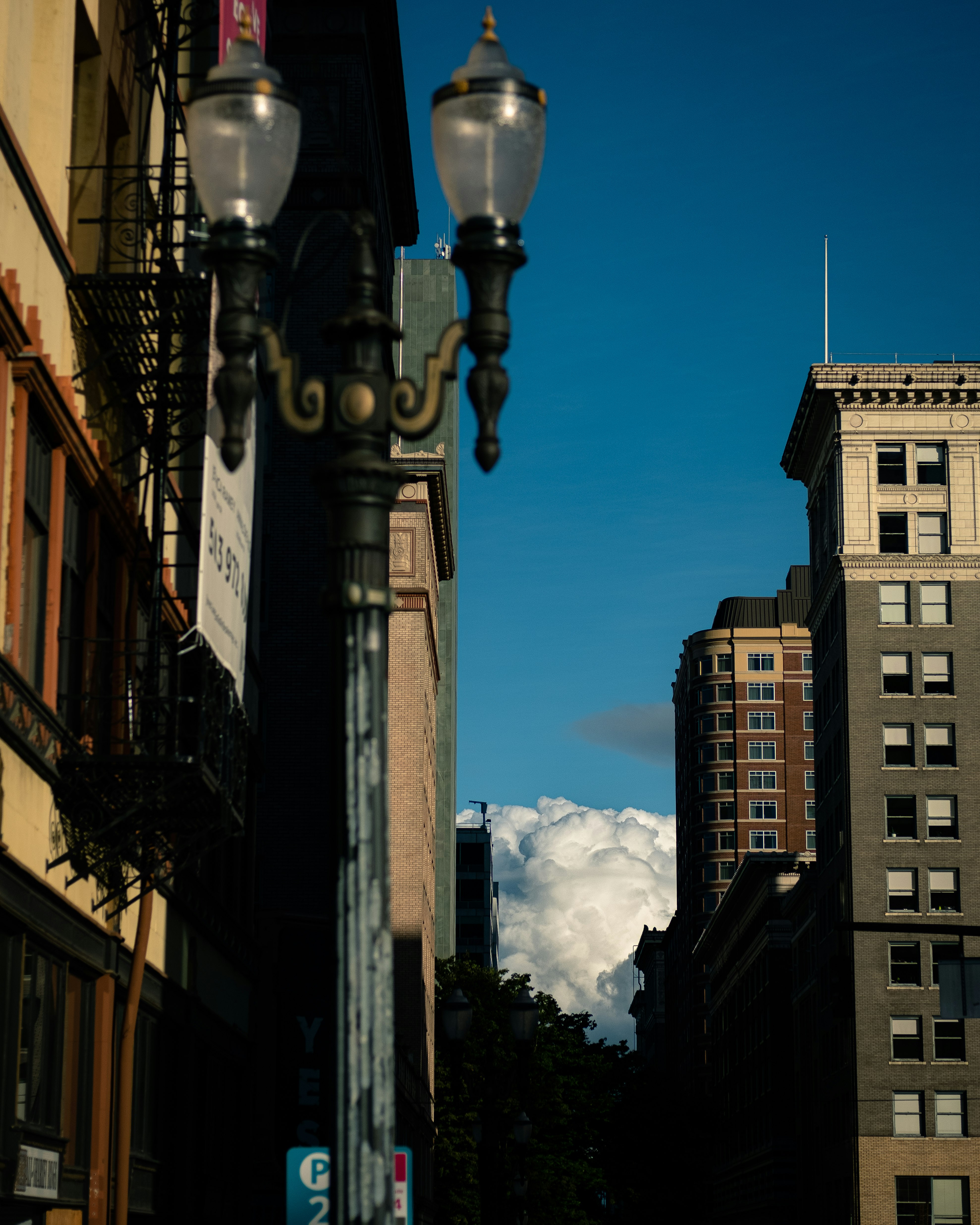 black street light near brown concrete building during daytime